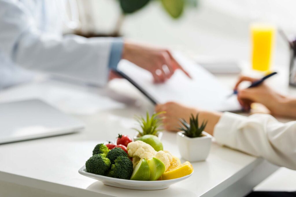 selective focus of tasty organic fruits and vegetables near wome